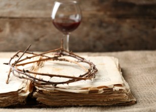 Crown of thorns and bible on old wooden background